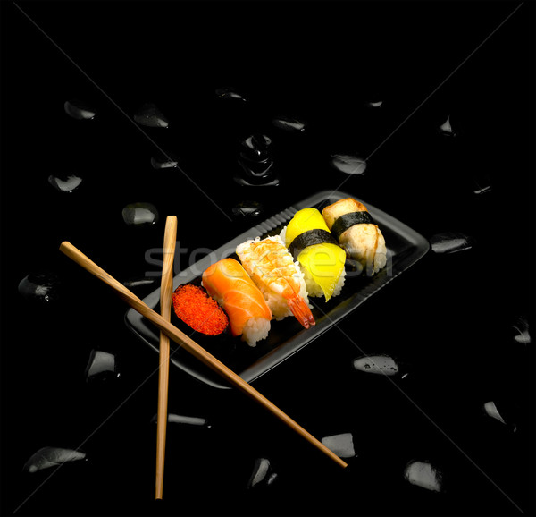 Sushis plaque noir cailloux poissons fond Photo stock © keko64