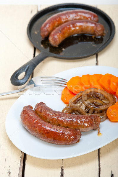 Stock photo: beef sausages cooked on iron skillet 