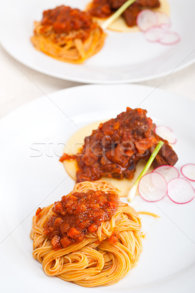 pasta with pork ribbs sauce on polenta bed Stock photo © keko64