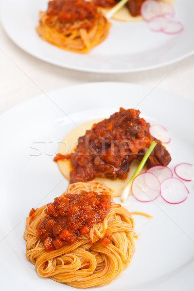 pasta with pork ribbs sauce on polenta bed Stock photo © keko64
