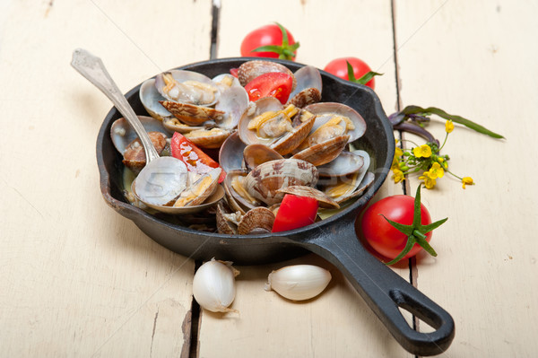 Stock photo: fresh clams on an iron skillet