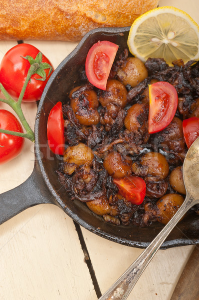 Stock photo: Baby cuttle fish roasted on iron skillet