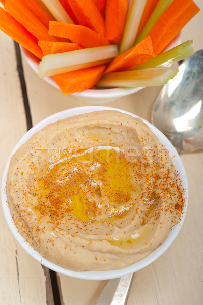 Stock photo: fresh hummus dip with raw carrot and celery 