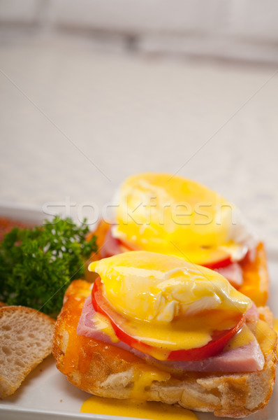 eggs benedict on bread with tomato and ham Stock photo © keko64