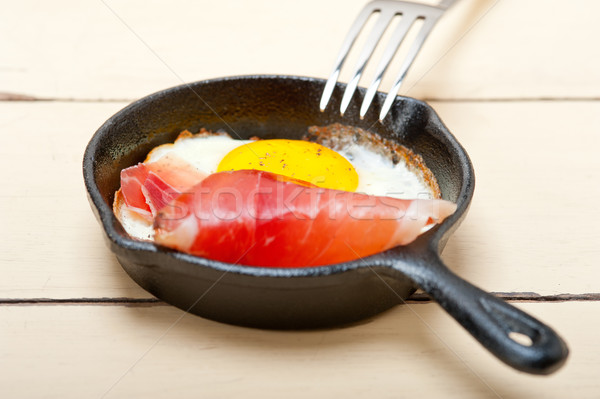 egg sunny side up with italian speck ham Stock photo © keko64