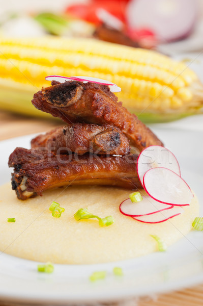 pork ribbs on polenta corn cream bed Stock photo © keko64