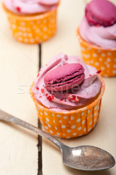 pink berry cream cupcake with macaroon on top Stock photo © keko64
