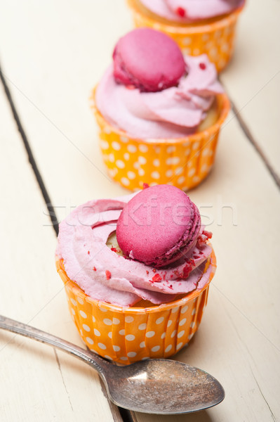 pink berry cream cupcake with macaroon on top Stock photo © keko64