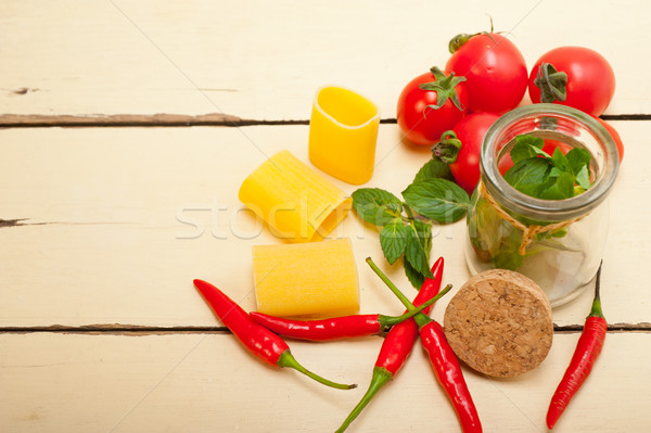 Italian pasta paccheri with tomato mint and chili pepper Stock photo © keko64