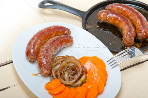 Stock photo: beef sausages cooked on iron skillet 