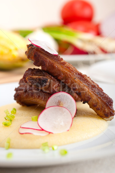 pork ribs on polenta corn cream bed Stock photo © keko64