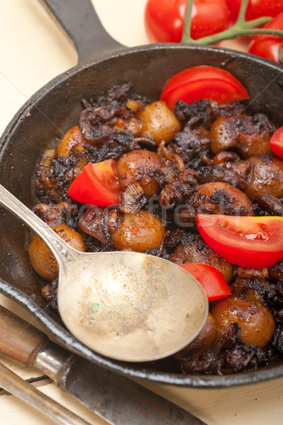 Stock photo: Baby cuttle fish roasted on iron skillet