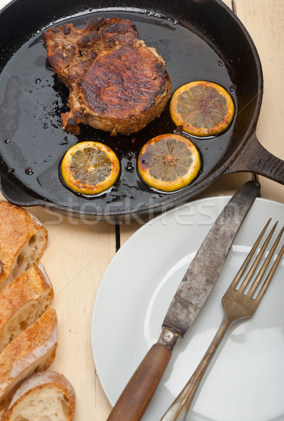 Stock photo: pork chop seared on iron skillet