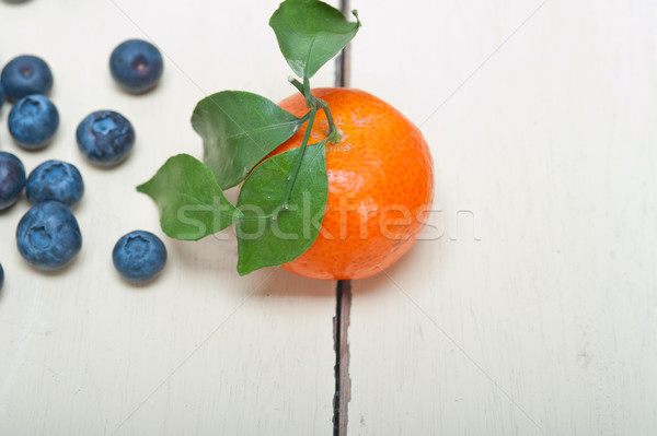 Mandarina arándano blanco mesa rústico mesa de madera Foto stock © keko64