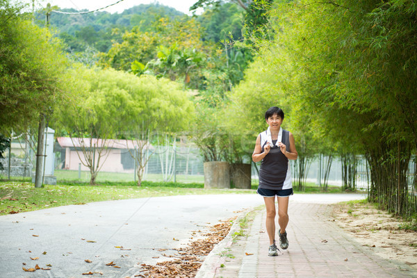 Fronte view senior donna jogging parco Foto d'archivio © kenishirotie