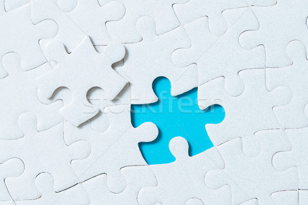 Jigsaw puzzle pieces on blue background Stock photo © kenishirotie