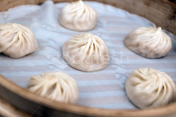 Shanghai steamed bun in small bamboo basket. Stock photo © kenishirotie