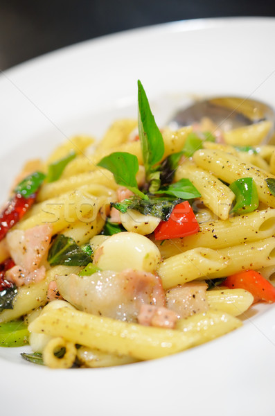 Stock photo: Penne pasta with ham and basil, Italian food.