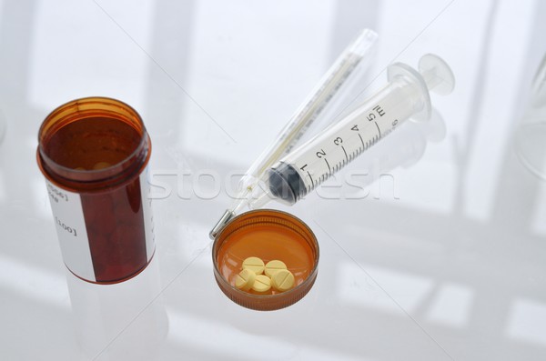 pills with pill bottle and syringe, thermometer Stock photo © Kheat