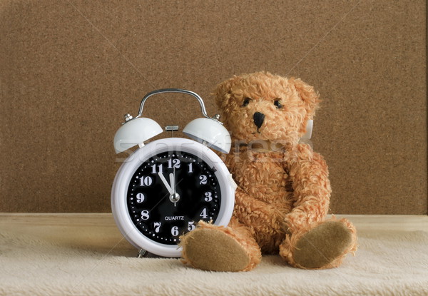 Teddy bear with alarm clock on wooden Stock photo © Kheat