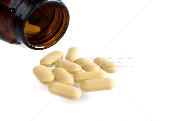 Pills from bottle on white Stock photo © Kheat