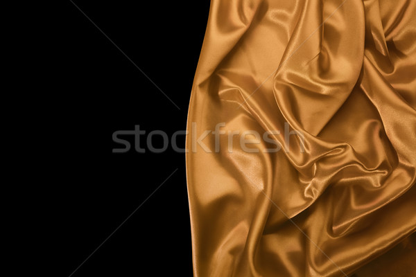 Sedoso dourado tecido isolado preto textura Foto stock © klikk
