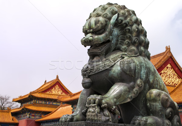 Beijing Forbidden City: lion statue against the roofs. Stock photo © Klodien