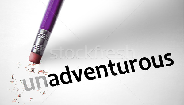 Eraser changing the word Unadventurous for Adventurous  Stock photo © klublu