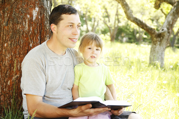 young father with his little daughter reads the Bible Stock photo © koca777