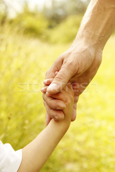 parent holds the hand of a small child  Stock photo © koca777