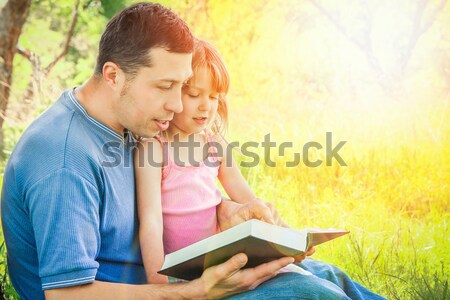  father with his little daughter reads the Bible Stock photo © koca777