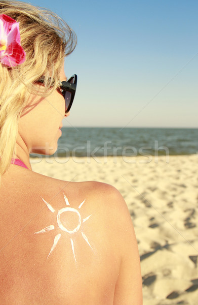 of sun cream on the female back on the beach Stock photo © koca777