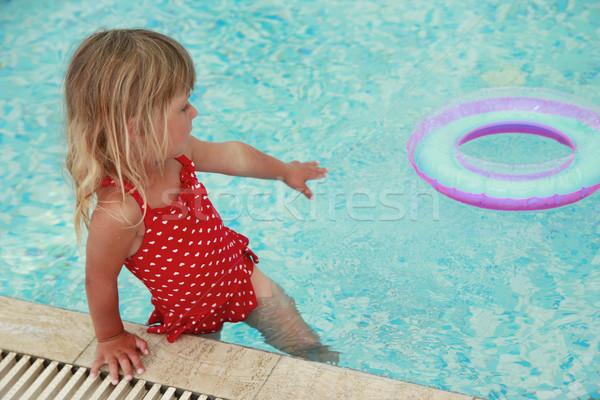 girl swims in a pool with a circle Stock photo © koca777