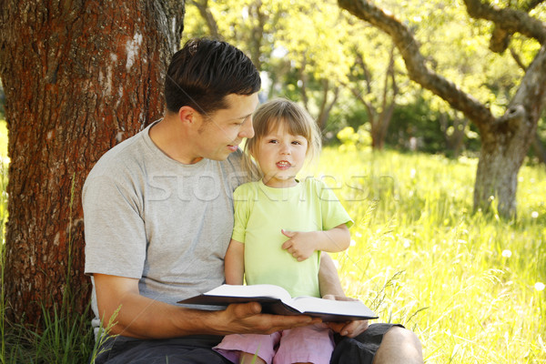  father with his little daughter reads the Bible Stock photo © koca777