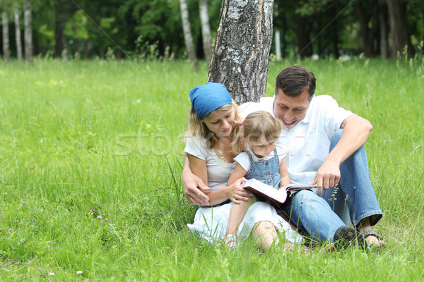 Fiatal család olvas Biblia természet gyerekek Stock fotó © koca777