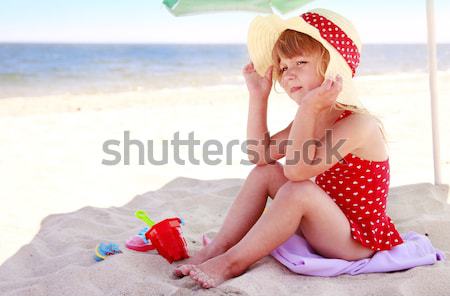 Stock photo: little girl playing on the sea shore