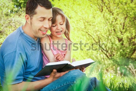  father with his little daughter reads the Bible Stock photo © koca777