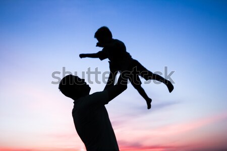 Stock photo: silhouette of father and son play