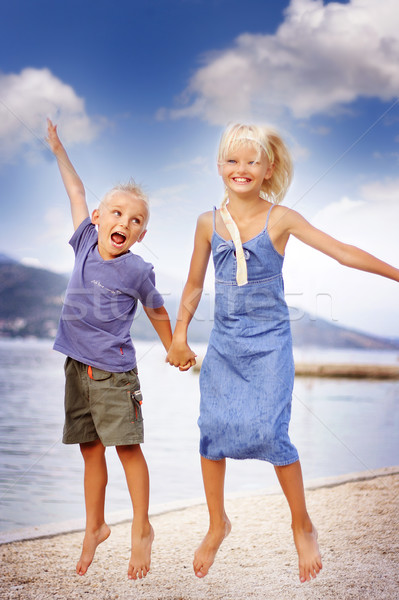 boy and girl jumping Stock photo © konradbak