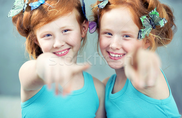 Portrait of two cheerful redhead twins Stock photo © konradbak