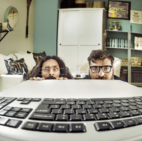 Two funny computer scientits staring at a keybord Stock photo © konradbak