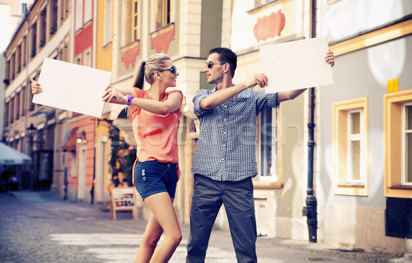 Cute couple with advertise Stock photo © konradbak