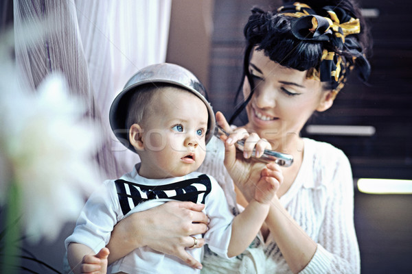 Beauty woman and baby with saucepan Stock photo © konradbak