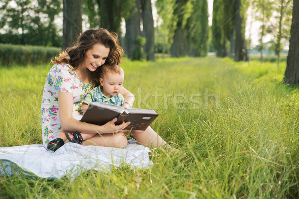 Brunette  mother reading tales for her child Stock photo © konradbak