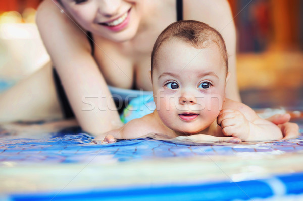 Mother and baby relaxing in the swimming pool Stock photo © konradbak