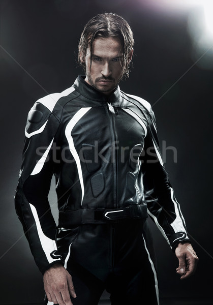 Handsome man wearing motorbike uniform Stock photo © konradbak