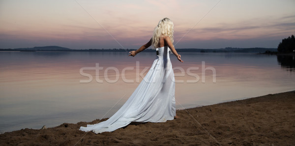 Lonely woman walking by the lakeside Stock photo © konradbak