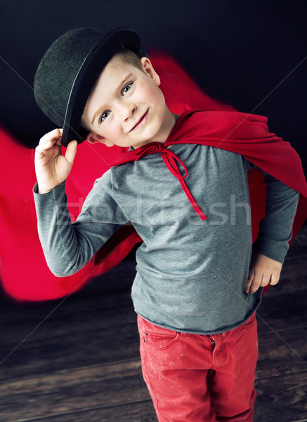 Mały elegancki magik chłopca dotknąć hat Zdjęcia stock © konradbak
