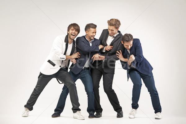 Stock photo: Amused guys having a great fun