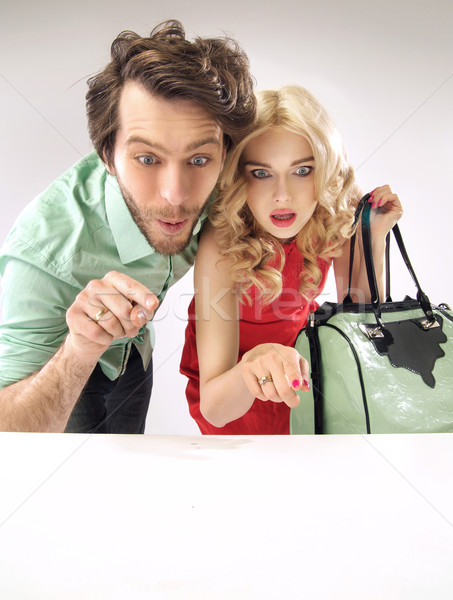Amazed couple staring at sales Stock photo © konradbak
